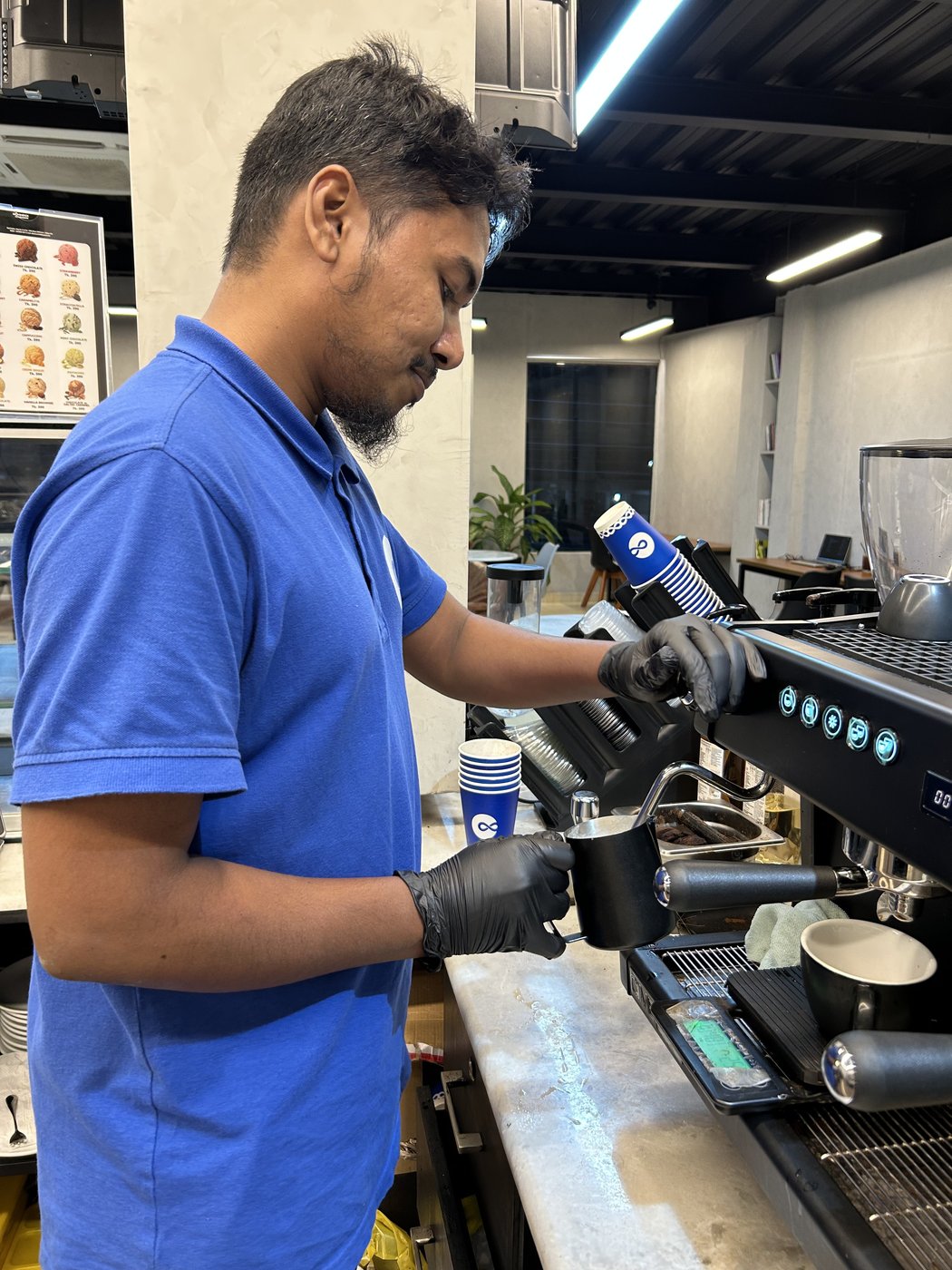 Barista steaming milk at the Epifin training counter